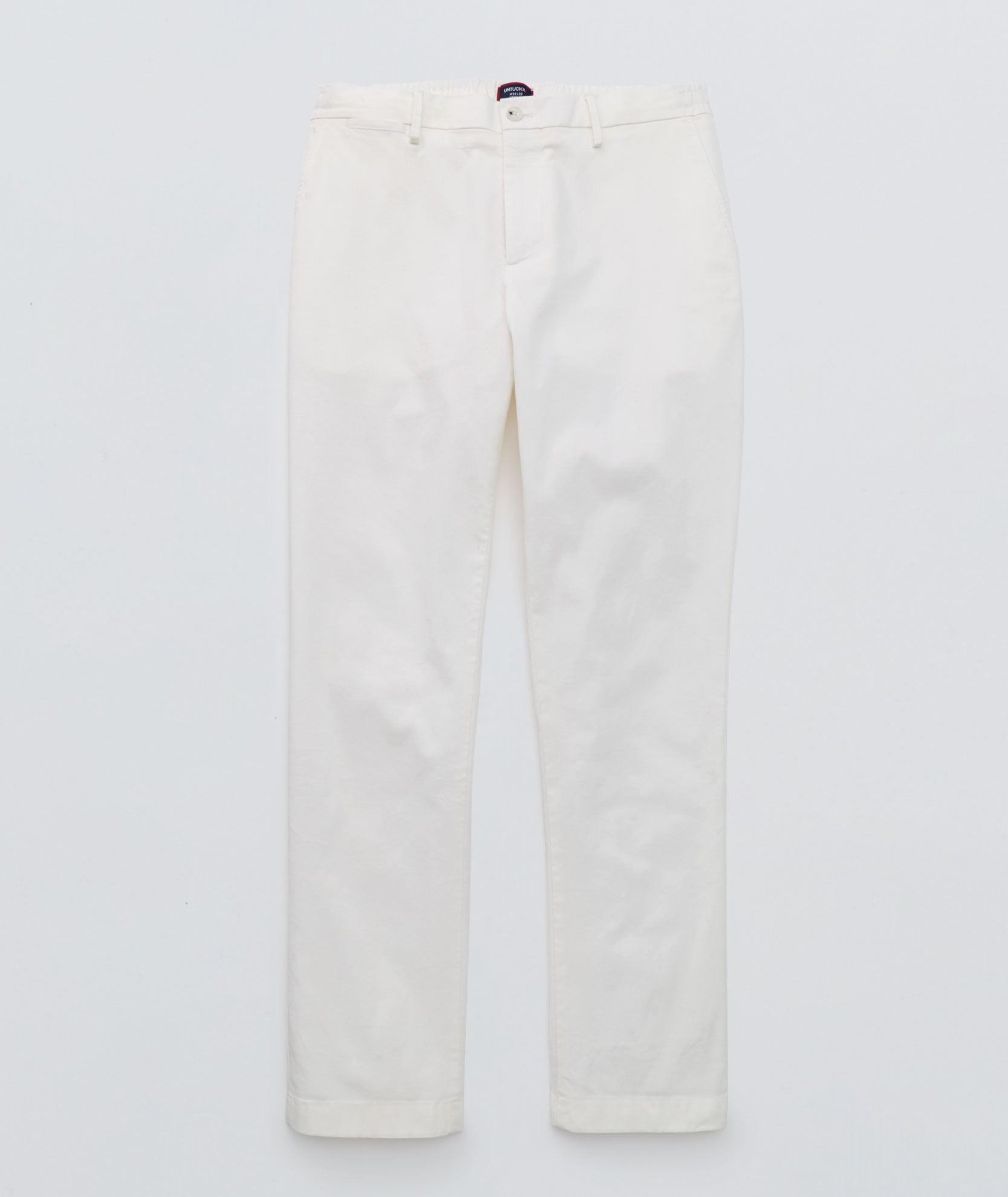 Model is wearing UNTUCKit Stretch Cotton Hybrid Pant in Cream. 