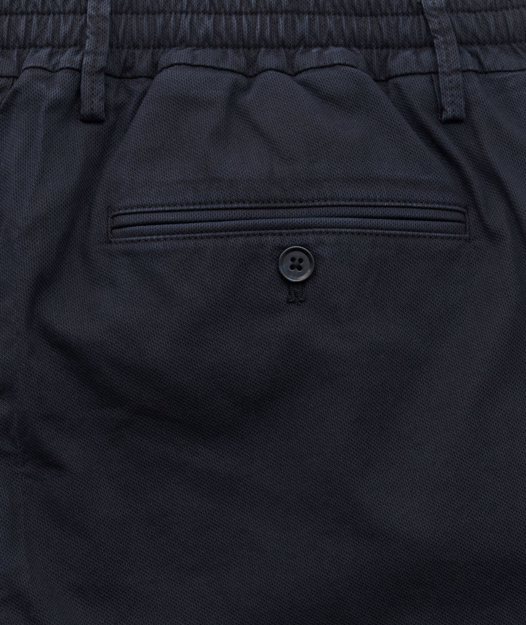 Model is wearing UNTUCKit Stretch Cotton Hybrid Pants in Navy.