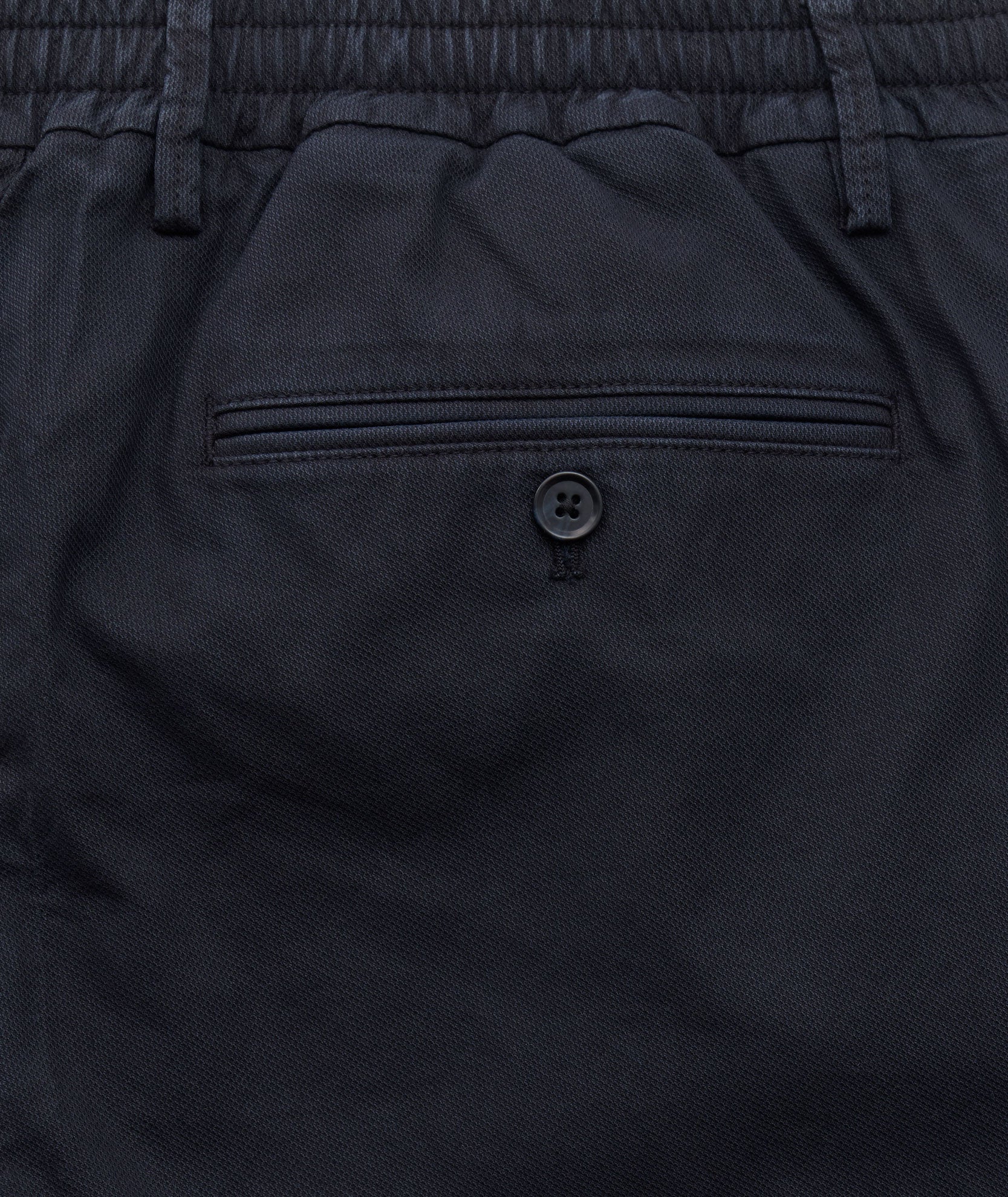 Model is wearing UNTUCKit Stretch Cotton Hybrid Pants in Navy.