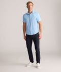 Model is wearing UNTUCKit Torre 5-Pocket Tech Pant in Black. 