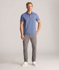 Model is wearing UNTUCKit 5-Pocket Performance Tech Pants in Gray.