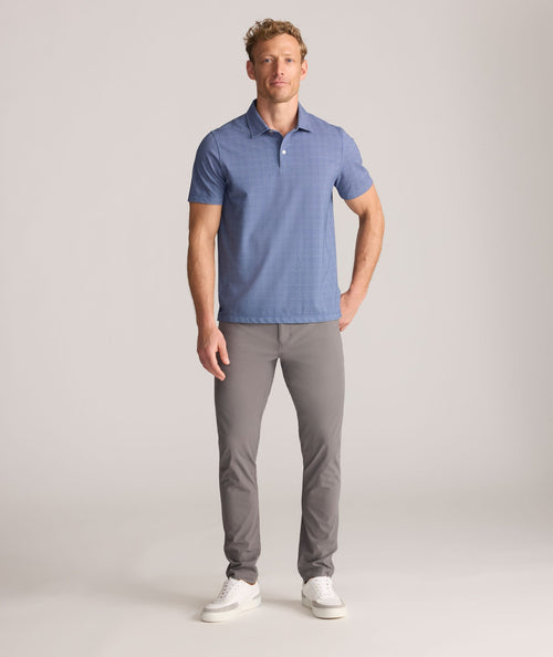 Model is wearing UNTUCKit 5-Pocket Performance Tech Pants in Gray.