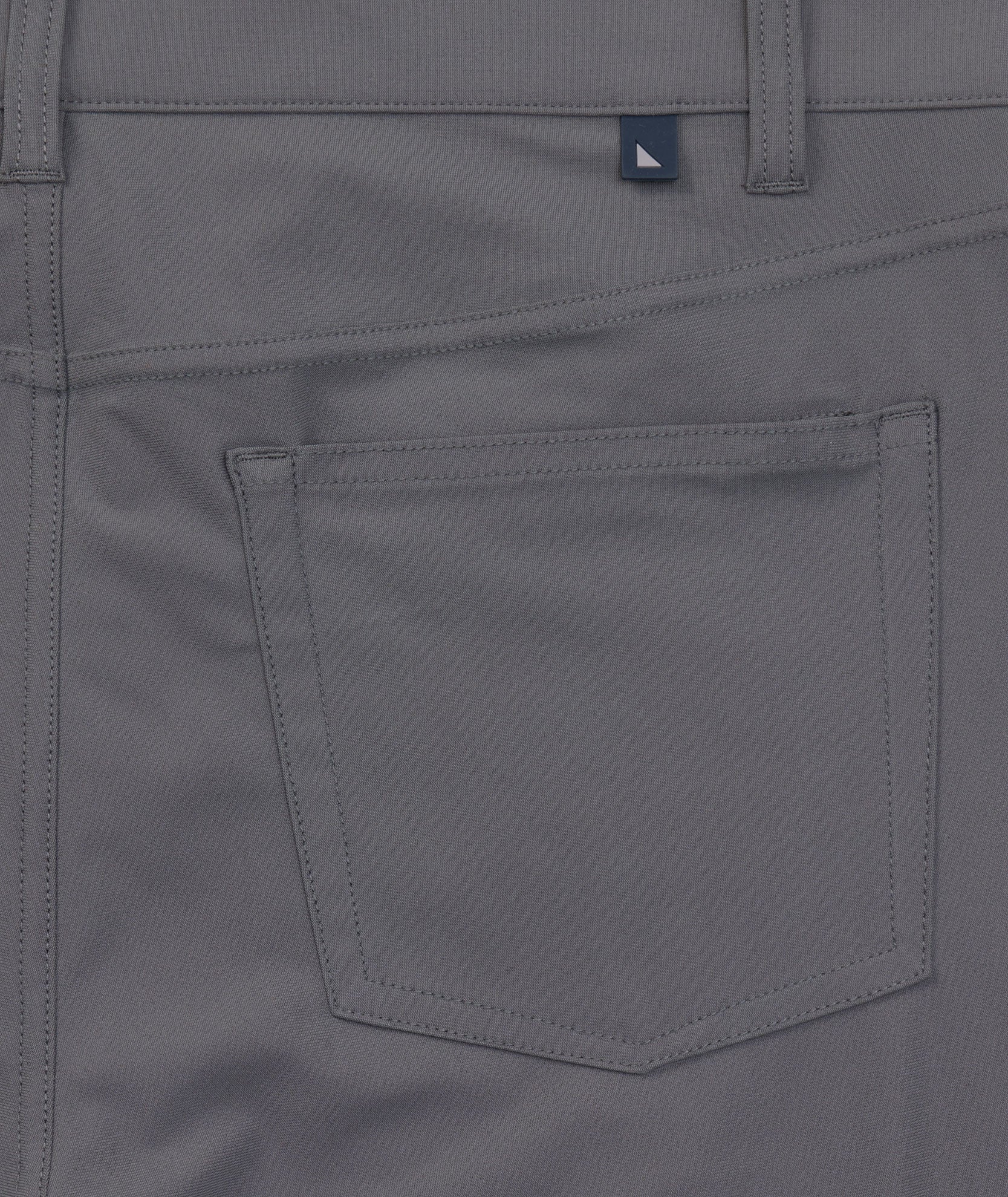 Model is wearing UNTUCKit 5-Pocket Performance Tech Pants in Gray.