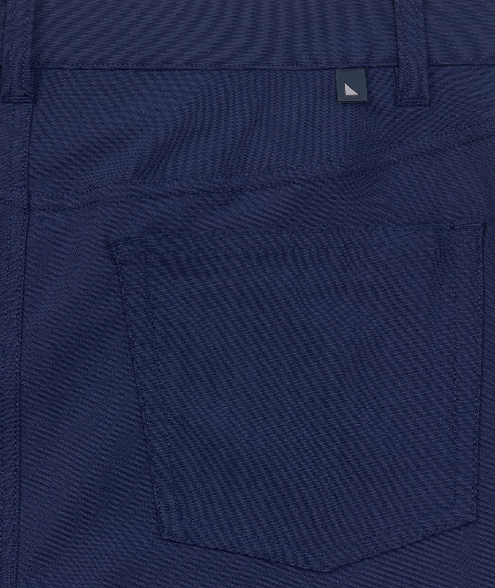 Model is wearing UNTUCKit 5-Pocket Performance Tech Pants in Navy.